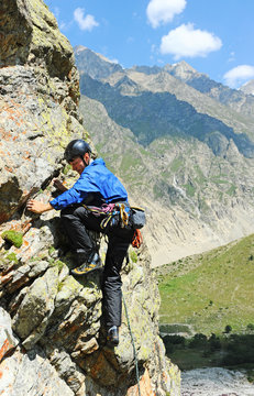 Young man climbing natural rocky