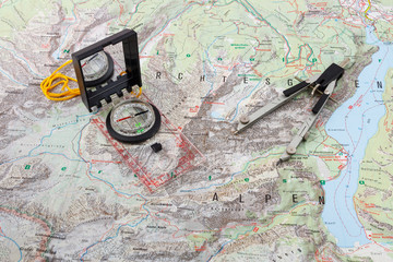 Compass and divider caliper on a hiking map