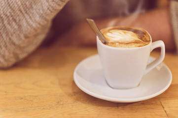 unrecognizable man drinking coffee and having breakfast.