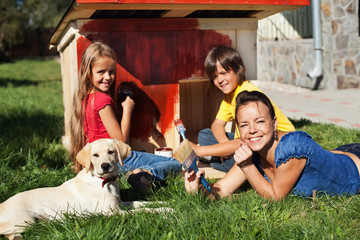 Happy family building a doghouse together