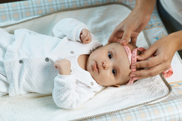 therapist measures  size head of  beautiful baby © Аrtranq