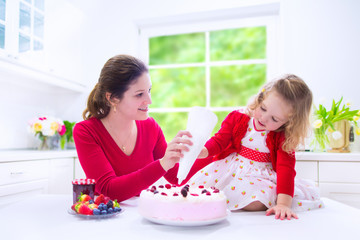 Mother and daughter baking strawberry pie