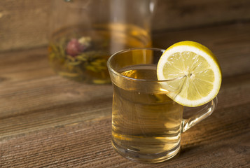 Teapot with tea and lemon slice