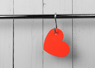 Red heart on stainless steel kitchen wall rack. Copy space.