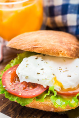 Burger with pouched egg and tomato