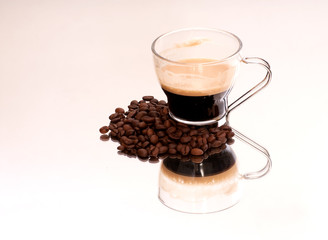 Coffee cup and coffee beans on a mirror