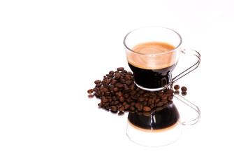 Coffee cup and coffee beans on a mirror