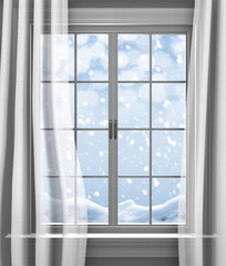 Fototapeta premium Winter snow falling outside the paned window of a house
