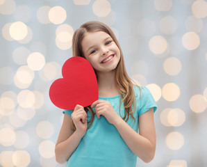 smiling little girl with red heart