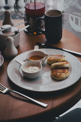 Breakfast with tea, coffee, sandwiches and cheesecakes in a cafe