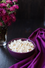 Delicious homemade cottage cheese on the wooden table