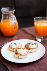 Delicious homemade cheese pancakes with fresh carrot juice