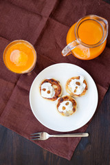 Delicious homemade cheese pancakes with fresh carrot juice