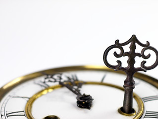 Old clock with roman numerals and key..