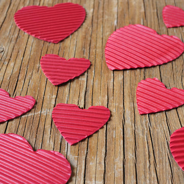 red hearts on a rustic wooden surface