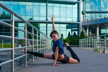 Girl sitting on the splits. Dance outdoor