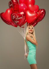Blond woman model with red balloons heart