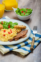Scrambled eggs with toast and fresh salad