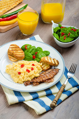Scrambled eggs with toast and fresh salad