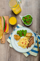 Scrambled eggs with toast and fresh salad