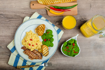 Scrambled eggs with toast and fresh salad