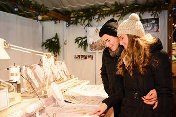 cheerful young couple doing winter shopping at night