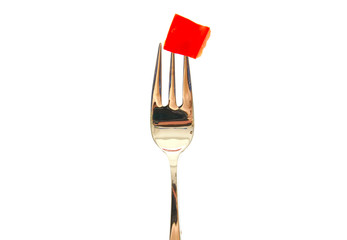 Fork with a red pepper slice isolated on white background.