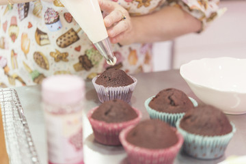 Young woman chef cooking cake in kitchen