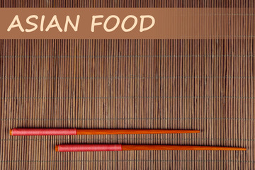 Pair of chopsticks and Asian Food text