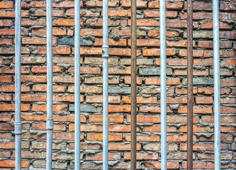 Iron bars with bricks wall background