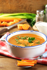 Composition with carrot soup, ingredients and herbs