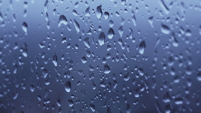 Rain droplets on a window intro scene on an angle