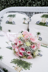 Bouquet of pink roses on sofa