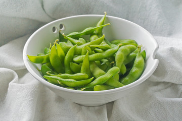 boiled green soybeans on fabric background