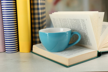 Color cup of tea with books