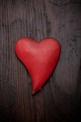 metallic heart with reflection on old wooden background
