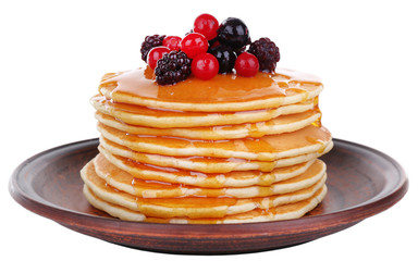 Stack of delicious pancakes with berries and honey isolated