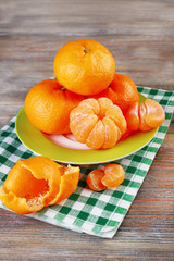 Tangerines in plate on table