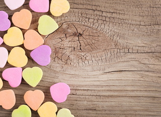 Colorful candy hearts on wooden background