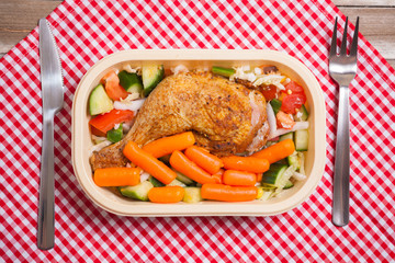 Delivery service grilled chicken with vegetables in plastic box