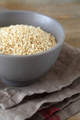 Sesame seeds in a bowl on boards
