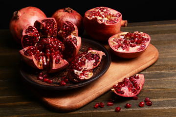 Ripe pomegranates on table close-up