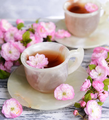 Beautiful fruit blossom with cup of tea