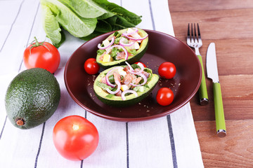 Tasty salad in avocado on plate table close-up