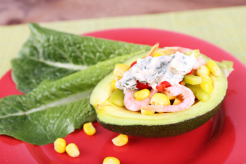 Tasty salad in avocado on plate close-up