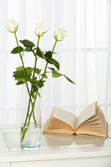 Beautiful bouquet of flowers in vase on window background