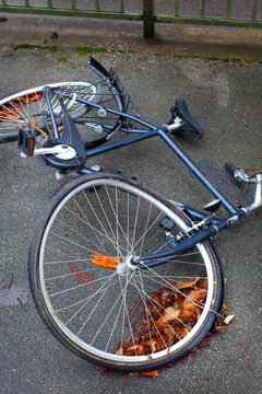 A bicycle with a buckled wheel from vandalism