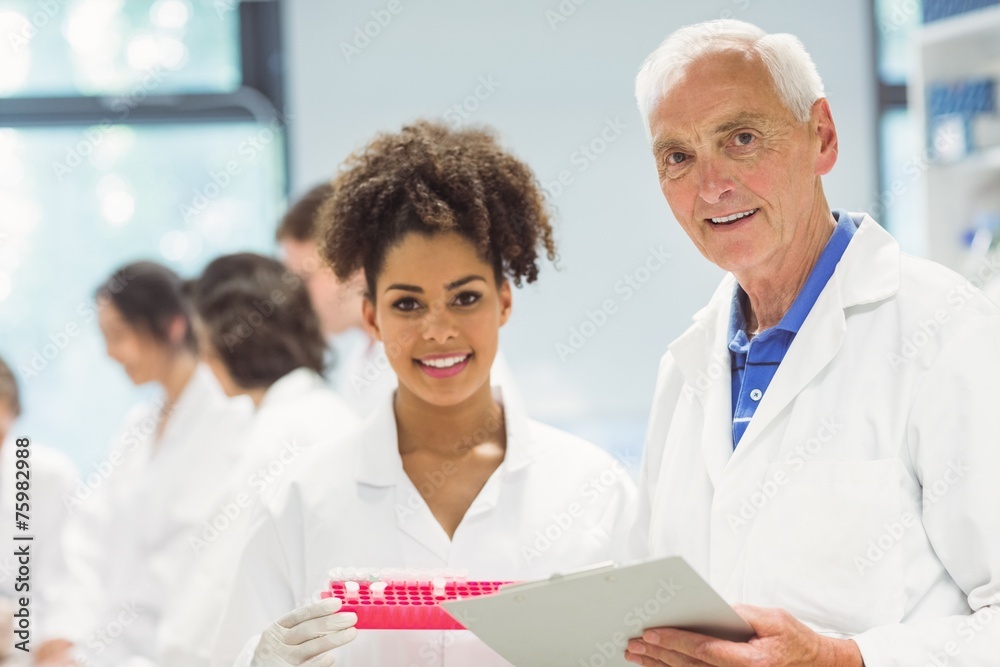Wall mural lecturer and student smiling at camera in the lab
