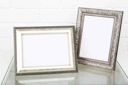 Photo Frames On Coffee Table On Brick Wall Background
