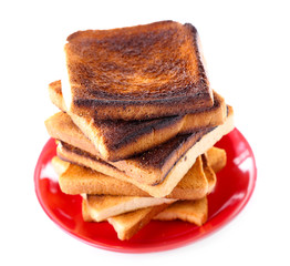 Burnt toast bread on plate, isolated on white background